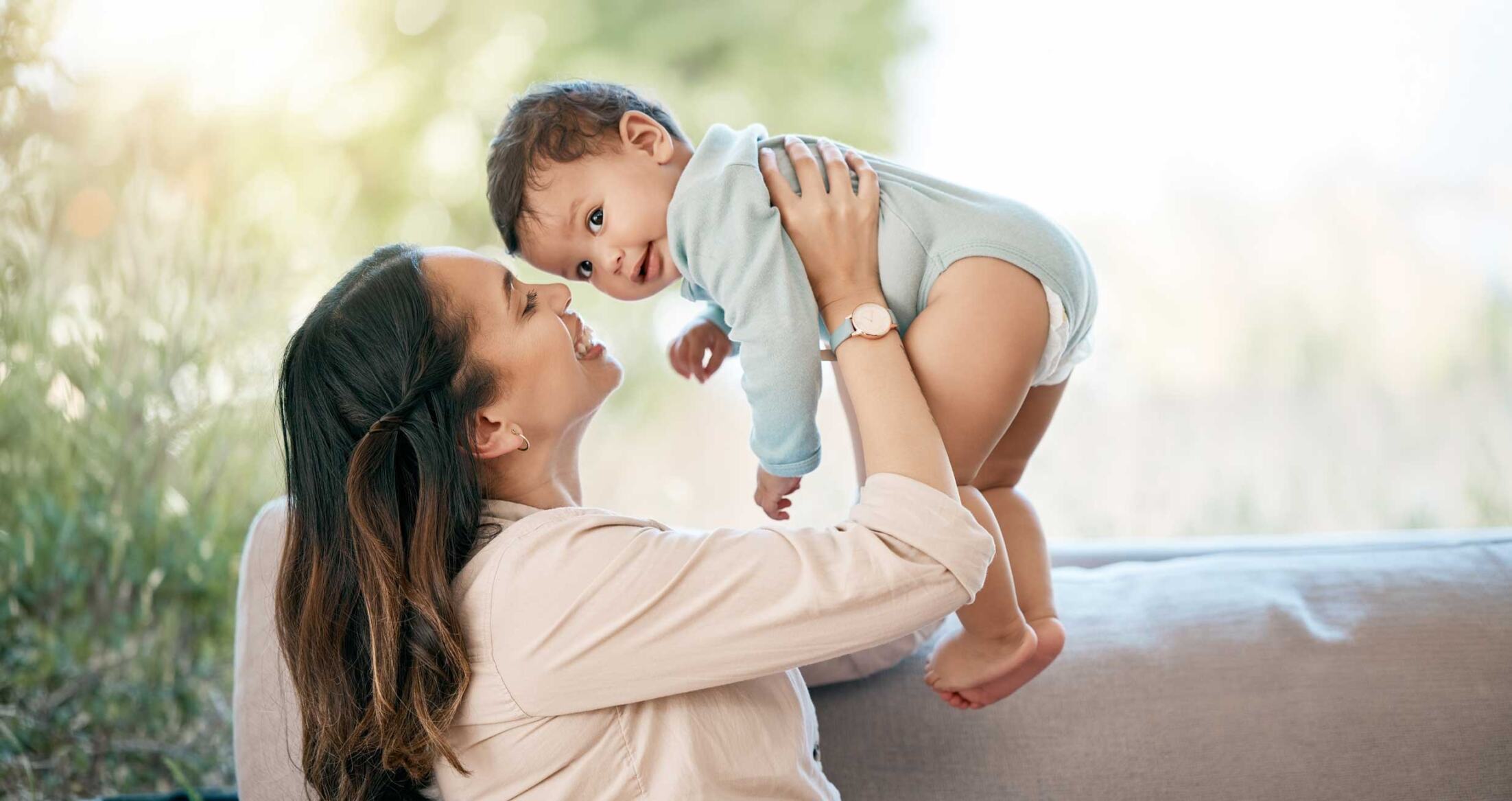 New mother holding her baby outdoors representing postpartum mental health support near Washington DC