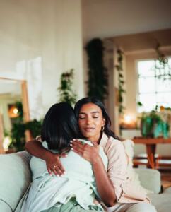 two-women-cormforting-each-other-over-postpartum-issues