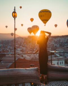 Perimenopauseal-woman-looking-out-at-hot-air-balloons