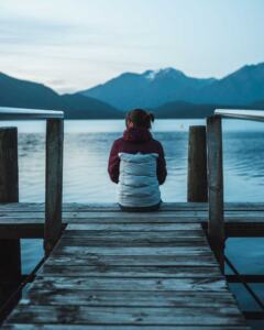 Woman-struggling-with-infertility-sitting-alone-on-a-dock